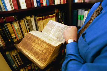 Ray Van Neste, director of the Center for Biblical Studies and instructor of Christian studies holds the 400-year-old newest addition to the center's library - the 1615 Geneva Bible. - Photo by Jim Veneman