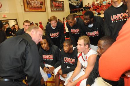 Head Coach Ralph Turner instructs his players during the huddle before Union's Homecoming game versus Robert Morris (Ill.) College. - Photo by Morris Abernathy
