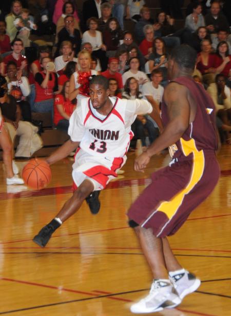 Junior guard Martez Hawkins drives to the basket around a Robert Morris (Ill.) College defender in Union's Homecoming win. - Photo by Morris Abernathy