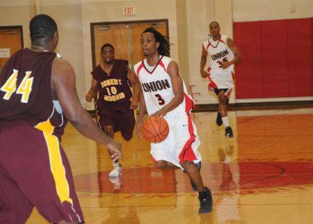 Tacuma Alexander (3) brings the ball down the floor in Union's Homecoming game versus Robert Morris (Ill.) College. - Photo by Morris Abernathy