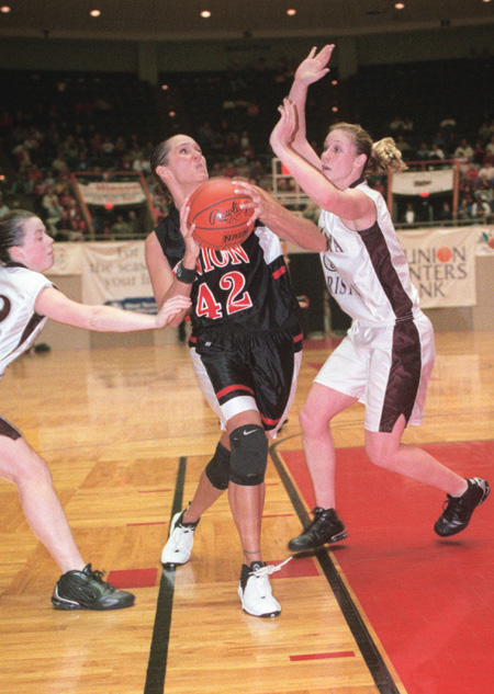 Junior forward Ginger Bryant charges to the basket at the national NAIA tournaments. Bryant has contributed 1,119 points and 672 rebounds during her career. In addition, Bryant received honorable mention NAIA All-American honors. The Lady Bulldogs’ season ended in the second round of the tournament with a 34-3 record. - Photo by Justin Veneman
