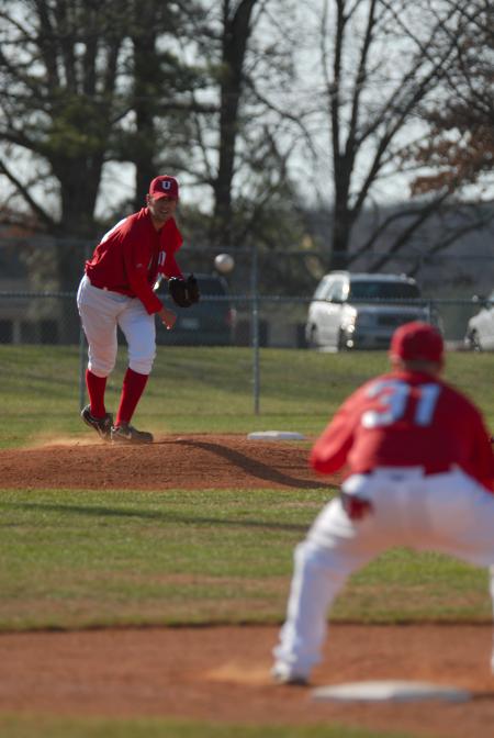 Senior pitcher Ben Ayris attempts to pick off the baserunner. - Photo by Morris Abernathy