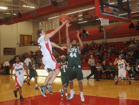 Junior guard Alan North (5) drives to the basket in Union's win over Life (Ga.) University. - Photo by Morris Abernathy