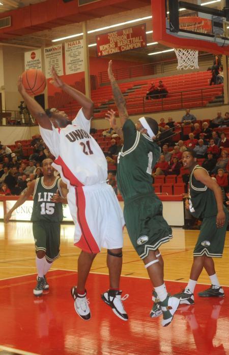 Senior forward Brian Lake (21) shoots over a Life (Ga.) University defender in the Bulldog's 122-80 win. - Photo by Morris Abernathy