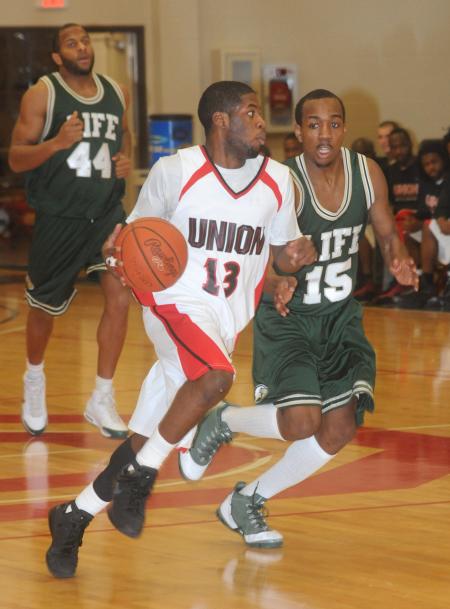 Junior guard Martez Hawkins (13) brings the ball down the floor in Union's 122-80 win over Life (Ga.) University. - Photo by Morris Abernathy