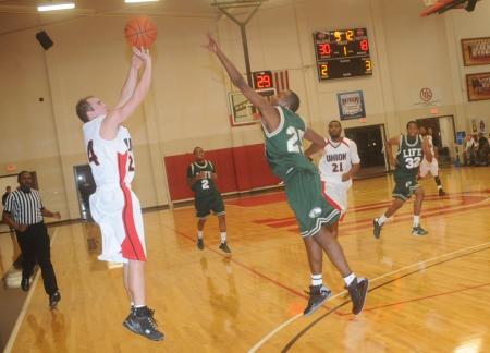 Senior guard Matt Neaville makes a three pointer over a defender in the Bulldog's win over Life (Ga.) University. - Photo by Morris Abernathy