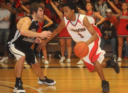 Junior guard Tacuma Alexander drives past a defender. - Photo by Morris Abernathy