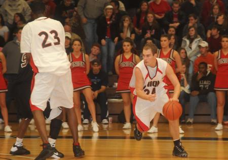 Senior guard Matt Neaville (24) dribbles around a screen in a game versus Freed-Hardeman (Tenn.) University. - Photo by Morris Abernathy