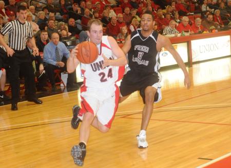 Matt Neaville (24), senior guard, drives around a Freed-Hardeman (Tenn.) defender to the basket. - Photo by Morris Abernathy