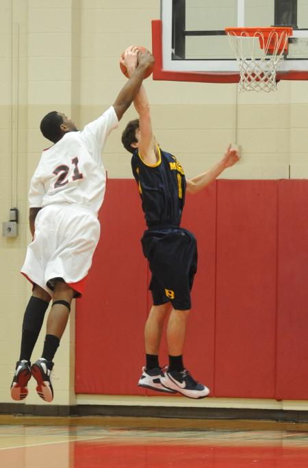 Brian Lake (21), senior forward, blocks a shot in Union's win over Blue Mountain (Miss.) College. - Photo by Morris Abernathy