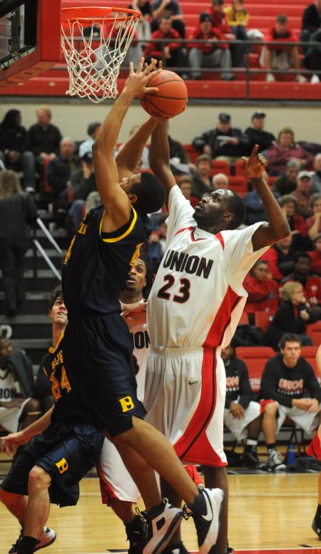 Greg Truvillion (23), junior forward, blocks a shot in the Bulldog's win over Blue Mountain (Miss.) College. - Photo by Morris Abernathy