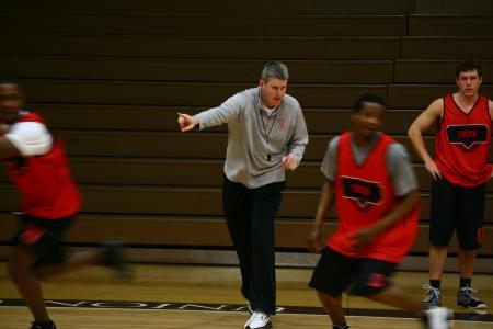 Coach David Niven, assistant men's basketball coach, runs a drill with players during a practice. - Photo by Kristi McMurry Woody