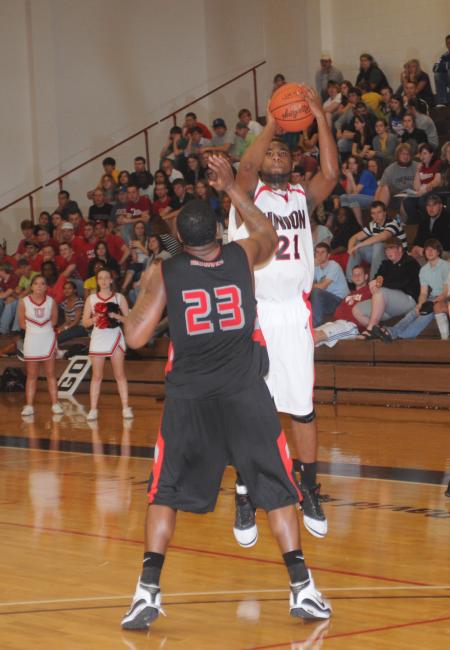 Brian Lake (21) shoots a three pointer over a Martin Methodist (Tenn.) College defender in Union's semifinal win in the TranSouth Conference Tournament. - Photo by Morris Abernathy