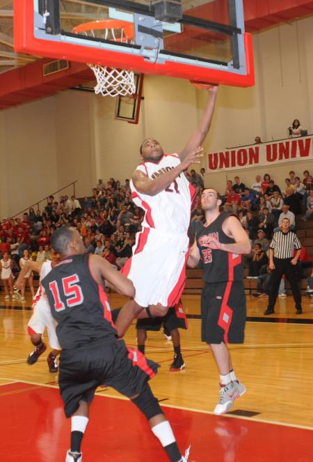 Brian Lake (21), senior forward, lays the ball in the basket during Union's 75-68 win over Martin Methodist (Tenn.) College in their semifinal game of the TranSouth Conference Tournament. - Photo by Morris Abernathy