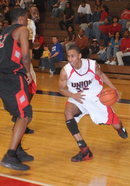 Keith Tolliver (35) drives around a defender to the basket. - Photo by Morris Abernathy