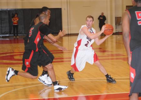 Matt Neaville (24) passes the ball to a teammate in Union's 75-68 win over Martin Methodist (Tenn.) College in the semifinal round of the TranSouth Conference Tournament. - Photo by Morris Abernathy
