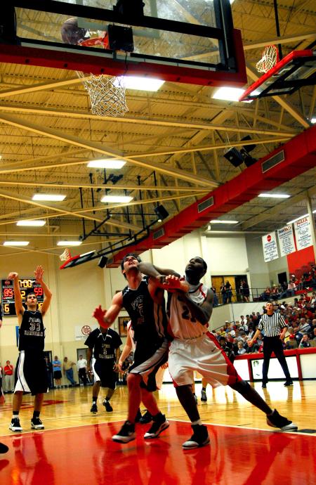 Brian Lake, senior sports management major, boxes out his Freed-Hardeman opponent during the TranSouth Tournament Championship Finals. - Photo by Kristi McMurry Woody