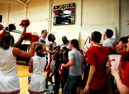 The Bulldogs pile into their cheering fans after winning the TranSouth Conference Tournament against Freed-Hardeman 105-78. - Photo by Kristi McMurry Woody