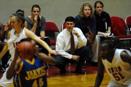 Coach Campbell encourages his players from the bench with little time to go in the first half of the first game in the NAIA tournament on Wednesday.  - Photo by Beth Spain