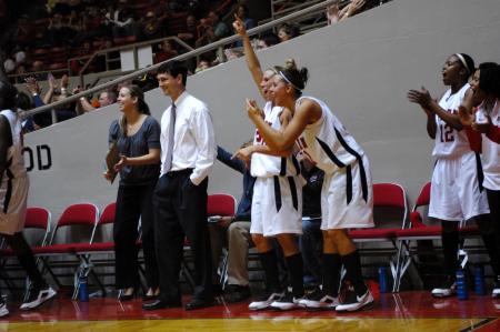 The bench cheers along with fans in the closing minutes of the Lady Bulldog's first victory in the NAIA Tournament on Wednesday.  - Photo by Beth Spain