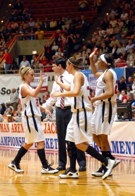 Coach Campbell and fellow teammates congratulate Kayla Hudson after a score during the semifinals of the 2009 NAIA tournament. - Photo by Kristi McMurry Woody