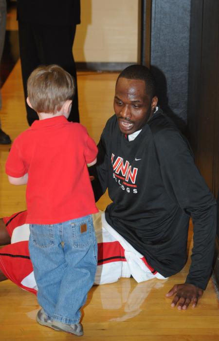 Junior forward Greg Truvillion greets a young fan before the TranSouth Conference Championship game. - Photo by Morris Abernathy