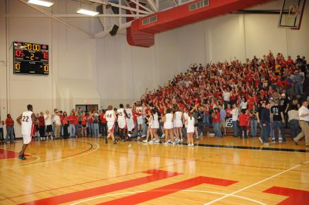 The Bulldogs run to celebrate their 105-78 win over Freed-Hardeman (Tenn.) University in the TranSouth Conference Tournament championship with Union fans. - Photo by Morris Abernathy