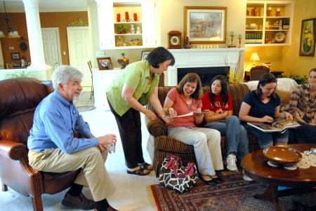 Alice Nettles, wife of physics professor Dr. Bill Nettles, gets her guest Rebecca Eaton, sophomore mathematics major, to sign her guestbook during Be Our Guest.   - Photo by Kristi McMurry Woody