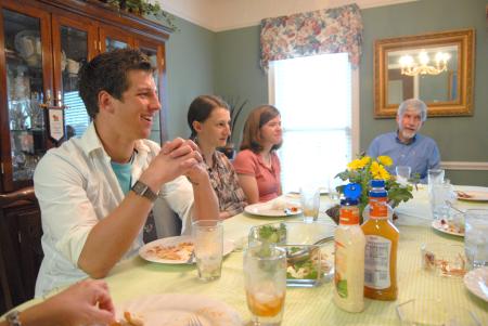 J. Landham, freshman, Hannah Williams, sophomore athletic training major, and Rebecca Eaton, sophomore mathematics major, laugh over a home-cooked meal at the home of Bill and Alice Nettles as part of Be Our Guest. - Photo by Kristi McMurry Woody