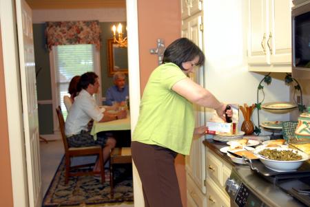Alice Nettles, wife of Dr. Bill Nettles, prepares dessert for her guests.  Union students dined at the Nettles' home as a part of Be Our Guest. - Photo by Kristi McMurry Woody