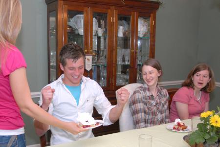 Emily Chambers, freshman youth ministry major, serves J.Landham, freshman, his strawberry shortcake overflowing with whipped cream at the home of Bill and Alice Nettles.  The Nettles served six Union students a home-cooked meal as part of Be Our Guest. - Photo by Kristi McMurry Woody
