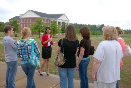 Haley Gallagher, sophomore business administration major, gives prospective students and their family members a tour of the campus during a preview day.  - Photo by Kristi McMurry Woody
