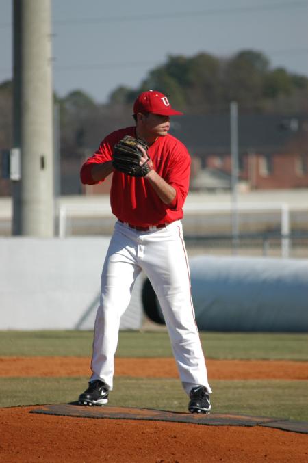 Union senior Danny Alberty looks in for his sign before he throws a pitch during practice. - Photo by Steven Aldridge