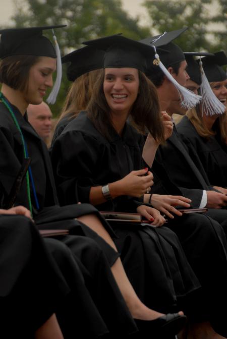 Ashley Diehm smiles at a friend after receiving her BA  in Teaching English As a Second Language during spring graduation. - Photo by Angela Abbamonte