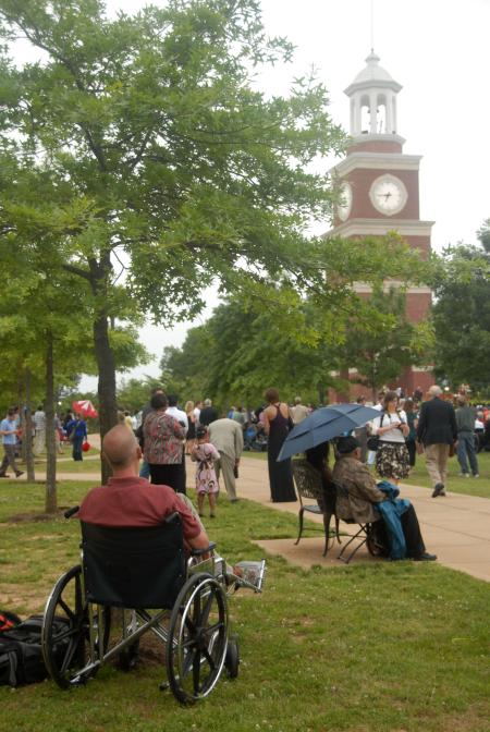 Staff Member of the Year &quot;Nurse&quot; Paul Mayer relaxes in a wheelchair at the spring graduation ceremony. - Photo by Angela Abbamonte