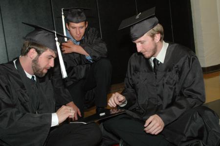 Graduates Kieler Henry, Matthew Lynn and John Henson play finger football while waiting to walk to graduation on Saturday, May 23, 2009. - Photo by Beth Spain