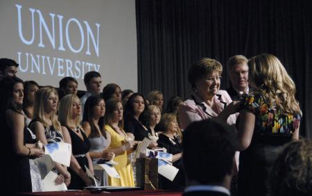 Chair of the undergraduate nursing program, Donna Latham, and Tim Smith, dean of the School of Nursing, lead the pinning portion of the Bachelor of Science in Nursing Recognition Service during Union's May 23 graduation festivities. - Photo by Jim Veneman