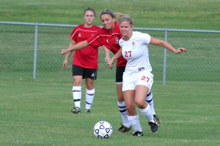 Katelin Dirksen, senior business administration major, dribbles ahead of two Christian Brothers opponents. - Photo by Kristi McMurry Woody