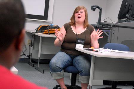 Katy Pope, senior art major, explains a game to her Focus group.  - Photo by Kristi McMurry Woody
