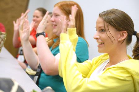 Freshmen Amanda Bennett and Hillary Craft play a game with their Focus group during new student orientation. - Photo by Kristi McMurry Woody