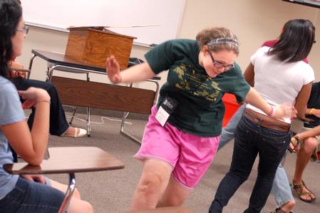 Stephanie Smith plays an icebreaker game with her Focus group during new student orientation. - Photo by Kristi McMurry Woody