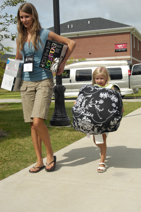 Sara Byars, nursing freshman from Dyersburg, Tenn., gets some help from her sister Ally Kate as they move things into her room. - Photo by Sarah Palmer Goff