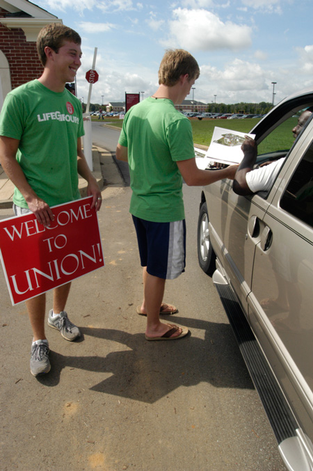 Ben Peacock, senior business major, and Grant Kelley, sophomore English major, greet people as they arrive at Union and give direction on where to go for move-in. - Photo by Sarah Palmer Goff