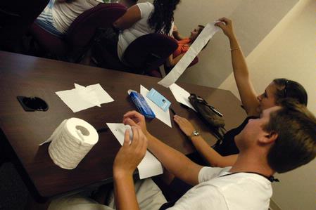 Freshmen Clayton Williams and Aly Giddens decide on how much toilet paper to take in a game during Focus. - Photo by Sarah Palmer Goff