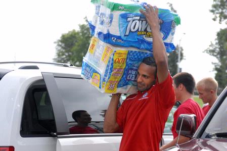 Diego Santos, freshman, helps a fellow classmate move into the dorms in the Heritage complex. - Photo by Kristi McMurry Woody