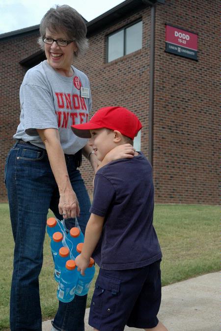Union education faculty member Dottie Myatt and Daniel Ellsworth, 6, help new students move into the Heritage Complex. - Photo by Beth Spain