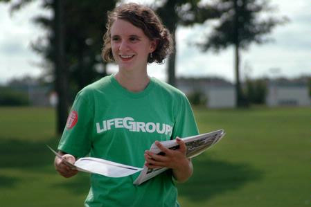 Sarah Brubaker, junior social work major, passes out maps to cars that come the entrances during new student move-in on Friday, August 21, 2009. - Photo by Beth Spain