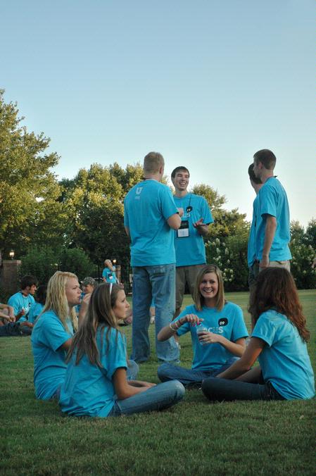 Students enjoy ice cream and new friends during an ice cream social at President Dockery's house during new student orientation. - Photo by Beth Spain
