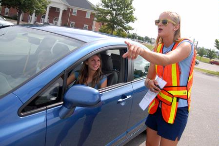 Bonnie Smith, junior business administration major, directs incoming freshman, Sarah Beth Byers, to the residence life complexes on freshman move-in day. - Photo by Kristi McMurry Woody