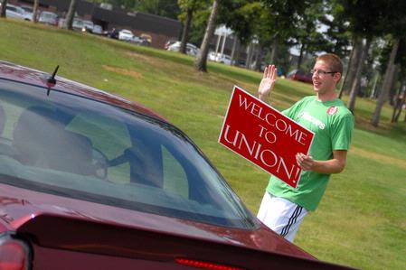 Luke Allison, sophomore mathematics major, directs incoming freshmen into Union on freshman move-in day. - Photo by Kristi McMurry Woody